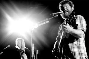 A black and white shot of the Manchester Orchestra performing under the spot light